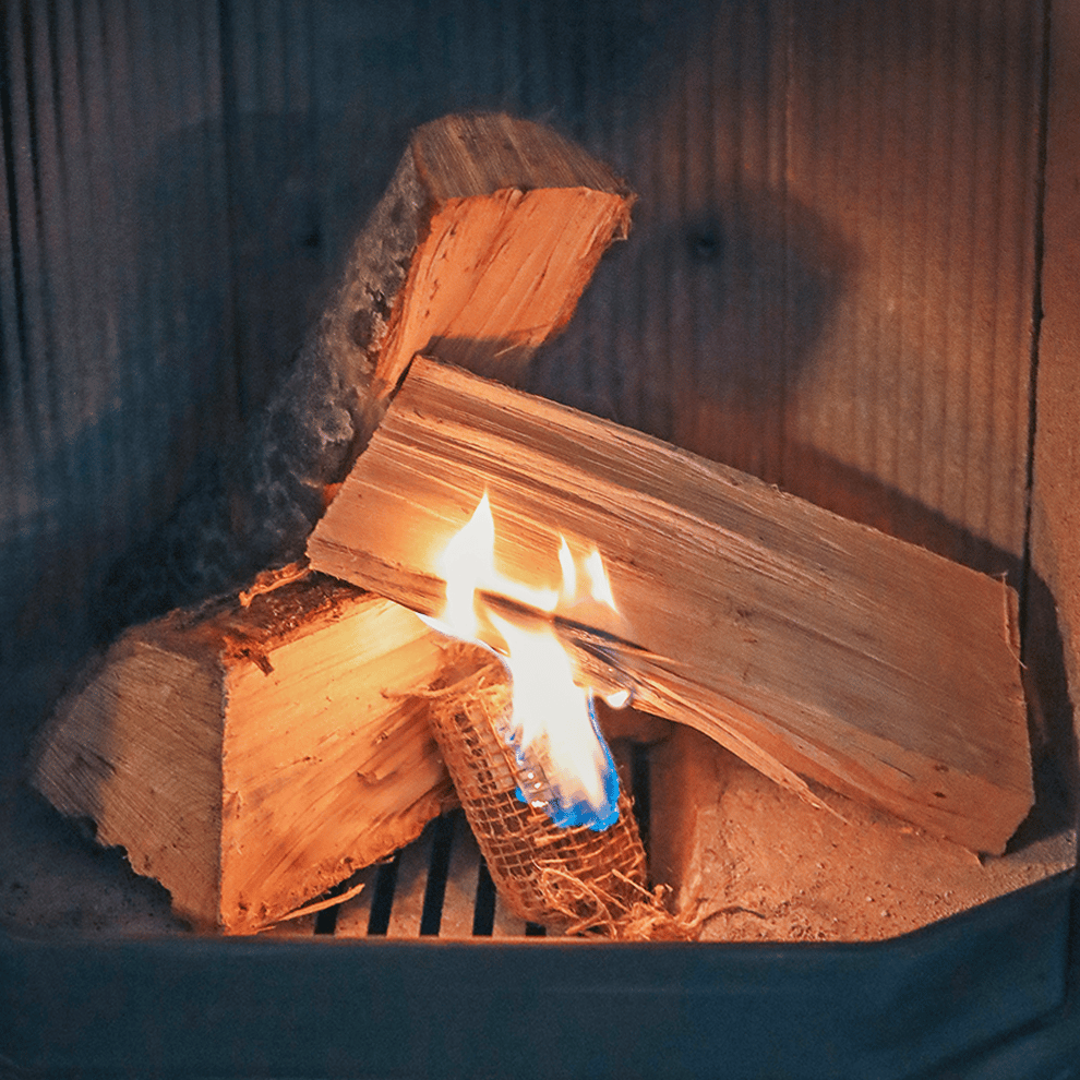 Anzünder Füür Bontjes, im Kamin mit Holzscheiten, die gerade anfangen zu brennen.