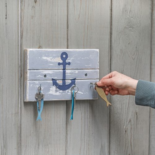 Rechteckiges Schl&uuml;sselbrett aus Holz, mit vier Haken und einem Anker als Motiv.