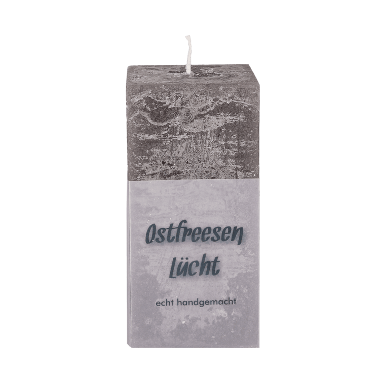 Eine eckige rustikale Kerze in der Farbe dark taupe mit der Aufschrift Ostfreesen Lücht echt handgemacht.